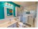 This bathroom features a glass shower with tile, storage cabinets and blue walls at 2105 Antioch Church Rd, Timberlake, NC 27583