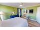 This bedroom features green walls, wood floors, and access to the bathroom at 2105 Antioch Church Rd, Timberlake, NC 27583