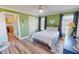 The bedroom features green walls, wood floors, and access to the Kitchen at 2105 Antioch Church Rd, Timberlake, NC 27583