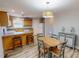 Well-lit kitchen with breakfast bar, wood cabinets, and laminate flooring at 2105 Antioch Church Rd, Timberlake, NC 27583