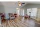 Open-concept living room with wood-look floors, light walls, and neutral furniture at 2105 Antioch Church Rd, Timberlake, NC 27583