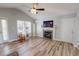 Bright living room with vaulted ceiling, fireplace, and wood-look floors at 2105 Antioch Church Rd, Timberlake, NC 27583