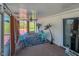 Relaxing screened-in patio featuring a ceiling fan, small seating arrangement, and views of the lawn at 2105 Antioch Church Rd, Timberlake, NC 27583