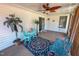 Cozy screened patio with comfortable seating, rug, and a ceiling fan at 2105 Antioch Church Rd, Timberlake, NC 27583