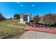 Backyard storage shed with concrete and gravel surround, well-kept landscaping, and clean design at 2105 Antioch Church Rd, Timberlake, NC 27583