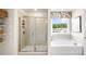 Bright bathroom with glass enclosed shower and soaking tub at 213 Umstead St, Sanford, NC 27330
