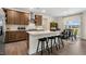 Modern kitchen featuring stainless appliances, large island with seating, and dark wood cabinetry at 213 Umstead St, Sanford, NC 27330