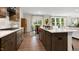 Open kitchen boasts stainless steel appliances, an island with a sink, and a view of the dining and living areas at 213 Umstead St, Sanford, NC 27330