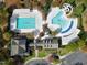 Aerial view of a community pool area featuring swimming pools, slides, and clubhouse facilities at 217 Waterford Lake Dr, Cary, NC 27519