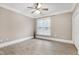 Bedroom featuring ceiling fan, large window, and wood-look flooring at 217 Waterford Lake Dr, Cary, NC 27519