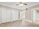 Bedroom featuring a ceiling fan, closets, wood floors, and an ensuite bath at 217 Waterford Lake Dr, Cary, NC 27519