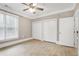 Spacious bedroom features a ceiling fan, two closets, and a large window at 217 Waterford Lake Dr, Cary, NC 27519