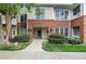 Inviting brick condo building with well-manicured landscaping and visible unit numbers at 217 Waterford Lake Dr, Cary, NC 27519