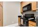 Bright kitchen with stainless appliances, granite counters, and wood cabinets at 217 Waterford Lake Dr, Cary, NC 27519