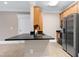 Modern kitchen boasting a black countertop, wood cabinets, and stainless steel refrigerator at 217 Waterford Lake Dr, Cary, NC 27519