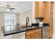 Well-lit kitchen featuring granite counters, stainless dishwasher and wood cabinets at 217 Waterford Lake Dr, Cary, NC 27519