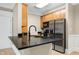 Kitchen featuring dark countertops, stainless steel refrigerator, and wood cabinetry at 217 Waterford Lake Dr, Cary, NC 27519