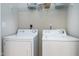 Convenient laundry room featuring a washer, dryer, and wire shelving for optimal storage solutions at 217 Waterford Lake Dr, Cary, NC 27519