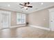 Open floor plan with light wood floors and multiple access doors at 217 Waterford Lake Dr, Cary, NC 27519