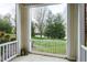 Cozy porch with white railings and a picturesque view of the lush green landscape beyond at 217 Waterford Lake Dr, Cary, NC 27519