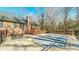 Back patio area with in ground pool, outdoor seating, and wooded landscape at 2440 Helena Moriah Rd, Timberlake, NC 27583