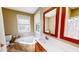 Bathroom featuring a soaking tub, tile floors, and wooden vanity at 2440 Helena Moriah Rd, Timberlake, NC 27583