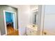 Clean, white bathroom with ample lighting and additional room accessible through the doorway at 2440 Helena Moriah Rd, Timberlake, NC 27583