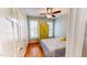 Bedroom with hardwood floors, ceiling fan, and yellow wardrobe at 2440 Helena Moriah Rd, Timberlake, NC 27583
