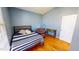 Cozy bedroom with hardwood floors, large bed, accent chair and desk, great natural lighting at 2440 Helena Moriah Rd, Timberlake, NC 27583