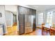 Dining area showing stainless steel refrigerator and custom cabinets and a view into the hallway at 2440 Helena Moriah Rd, Timberlake, NC 27583