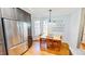 Bright dining area featuring a table with seating for four and stainless steel refrigerator at 2440 Helena Moriah Rd, Timberlake, NC 27583