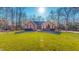 Charming single-story brick home with well-manicured lawn and mature trees against a bright, sunny sky at 2440 Helena Moriah Rd, Timberlake, NC 27583
