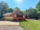 Exterior view of brick house with a garage, landscaping, and a pool in the back at 2440 Helena Moriah Rd, Timberlake, NC 27583