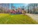 Side view of a brick home with manicured lawn and a driveway, showcasing the property's curb appeal at 2440 Helena Moriah Rd, Timberlake, NC 27583