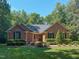 Charming brick home with manicured landscaping and mature trees at 2440 Helena Moriah Rd, Timberlake, NC 27583