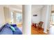 Cozy sitting area with a blue couch, decorative pillows and light-filled windows at 2440 Helena Moriah Rd, Timberlake, NC 27583