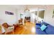 Spacious living area featuring hardwood floors, wainscoting, and a blue accent sofa at 2440 Helena Moriah Rd, Timberlake, NC 27583