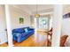 Cozy living room features a bay window, blue sofa, and two wicker chairs at 2440 Helena Moriah Rd, Timberlake, NC 27583