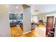 Open concept living room with a kitchen, exposed brick fireplace, hardwood floors, and lots of natural light at 2440 Helena Moriah Rd, Timberlake, NC 27583