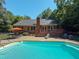 Backyard pool with lounge area, mature trees, and deck at 2440 Helena Moriah Rd, Timberlake, NC 27583
