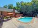 Backyard pool with a lounge area, patio, and mature trees at 2440 Helena Moriah Rd, Timberlake, NC 27583