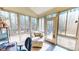 Bright sunroom with large windows offering scenic outdoor views and a comfortable seating area at 2440 Helena Moriah Rd, Timberlake, NC 27583