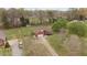 Aerial view of a brick home with large yard and mature trees at 2563 Millbrook Dr, Haw River, NC 27258
