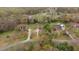 Aerial view of the home nestled among lush greenery, showcasing its tranquil and private setting at 2563 Millbrook Dr, Haw River, NC 27258