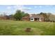 Expansive backyard featuring lush green grass and mature trees, perfect for outdoor activities at 2563 Millbrook Dr, Haw River, NC 27258