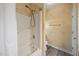 Bathroom featuring a shower and tub with a shower head, decorative wallpaper, and a toilet at 2563 Millbrook Dr, Haw River, NC 27258