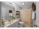 Bathroom featuring vanity, a large mirror, decorative shelves, and a shower with floral curtain at 2563 Millbrook Dr, Haw River, NC 27258