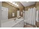 Bathroom featuring a white vanity, tiled walls, a large mirror, and a shower with a white curtain at 2563 Millbrook Dr, Haw River, NC 27258
