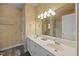 Bathroom featuring double sinks, a large mirror, decorative wallpaper, and a bathtub/shower combo at 2563 Millbrook Dr, Haw River, NC 27258
