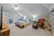 Bedroom with a ceiling fan, a bed with white comforter, and a seating area with chair at 2563 Millbrook Dr, Haw River, NC 27258